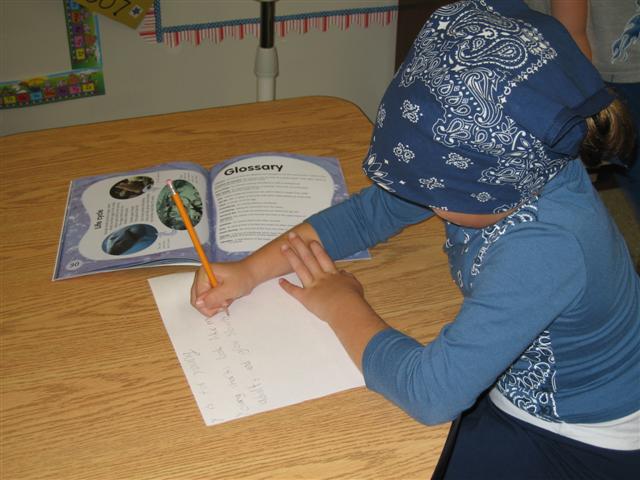 student writing on paper